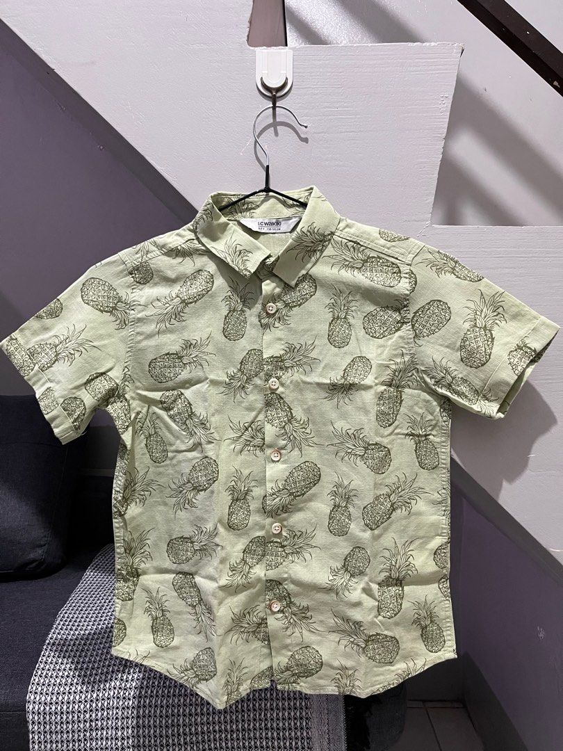 LC Waikiki Pineapple Print Shirt (Category: Babies & Kids Fashion) located in Angono. Submitted by dubibo (Listing ID 1414695305, Image 1). Description: - LC Waikiki shirt - Pineapple print - Size: 6-7 years (116-122cm) - Color: Light green - Features: Short sleeves, button-down front - Ideal for casual outings.