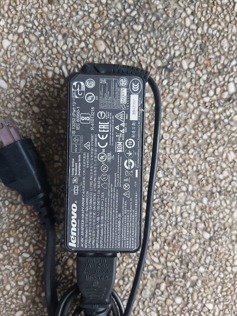 Lenovo Laptop Charger (Category: Chargers) located in Santa Rosa. Submitted by cristine83 (Listing ID 1414716624, Image 3). Description: - Genuine Lenovo charger - Black power adapter and cable - Adapter with regulatory markings - Includes velcro strap - Yellow, rectangular connector - Two-prong power plug.