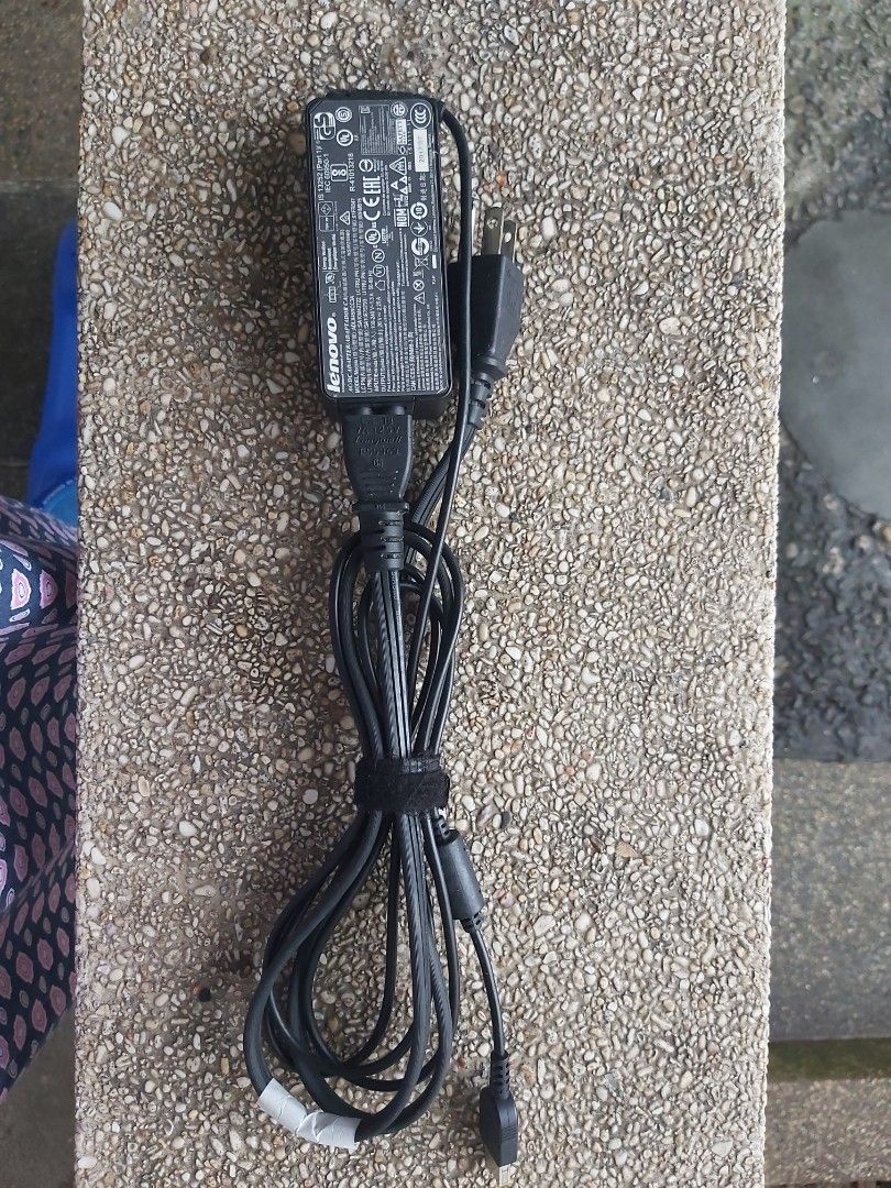 Lenovo Laptop Charger (Category: Chargers) located in Santa Rosa. Submitted by cristine83 (Listing ID 1414716624, Image 1). Description: - Genuine Lenovo charger - Black power adapter and cable - Adapter with regulatory markings - Includes velcro strap - Yellow, rectangular connector - Two-prong power plug.