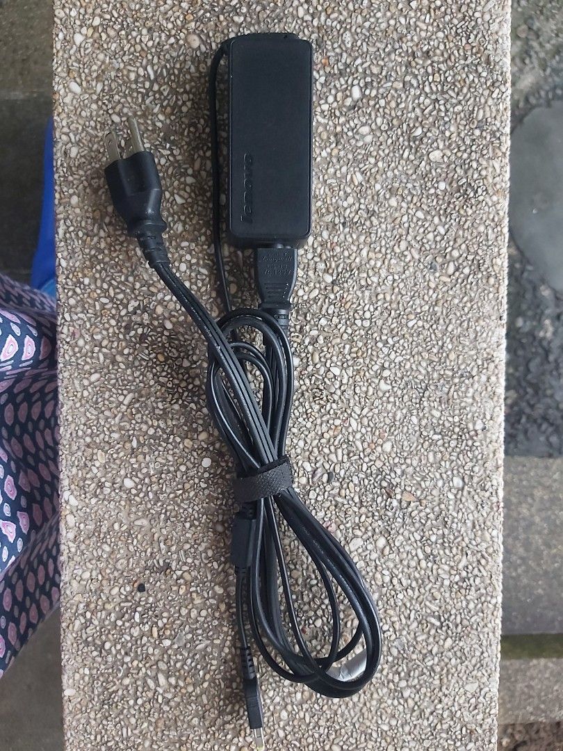 Lenovo Laptop Charger (Category: Chargers) located in Santa Rosa. Submitted by cristine83 (Listing ID 1414716624, Image 2). Description: - Genuine Lenovo charger - Black power adapter and cable - Adapter with regulatory markings - Includes velcro strap - Yellow, rectangular connector - Two-prong power plug.