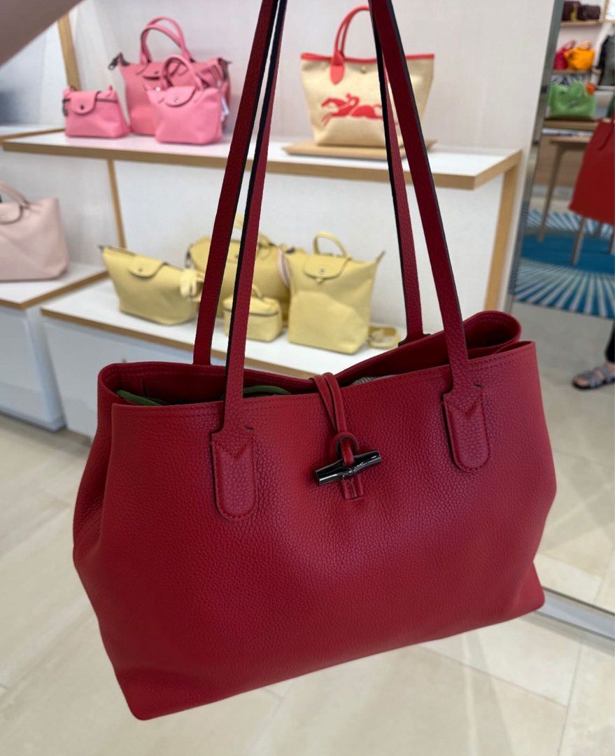 Longchamp Roseau Leather Tote Bag - Red (Category: Luxury Bags & Wallets) located in San Fernando. Submitted by currency_sy (Listing ID 1414810250, Image 1). Description: - Authentic Longchamp Roseau tote bag - Classic red color - Bamboo-style closure - Made of textured leather - Two top handles - Spacious interior.