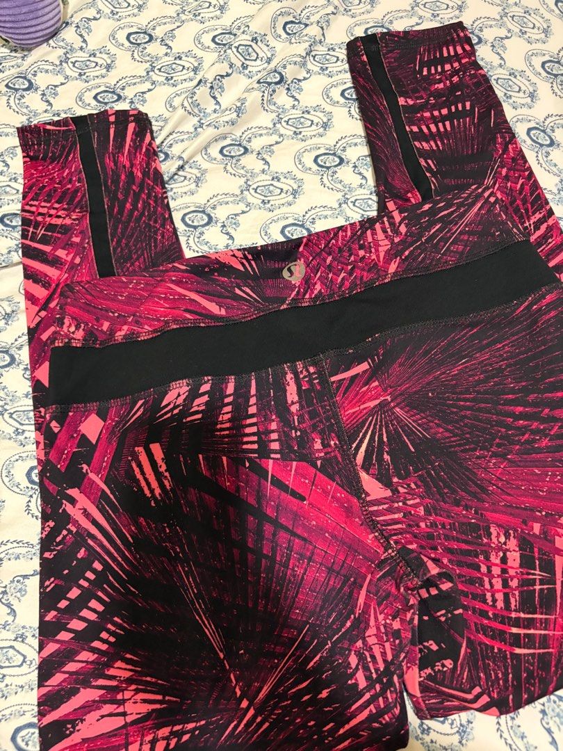 Lululemon Athletica Leggings Size 6 (Category: Activewear) located in Taguig. Submitted by allyjavierv (Listing ID 1414733335, Image 2). Description: - Lululemon Athletica leggings - Vibrant pink and black palm leaf print - Black waistband and side panels - Size: 6 - Designed in Vancouver - Made in Cambodia - Perfect for workouts or casual wear.
