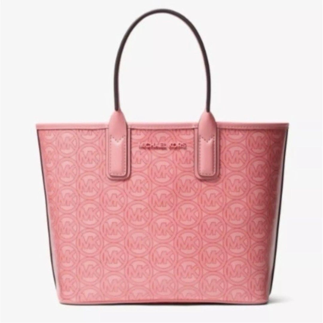 Michael Kors Jodie SM Tote - Grapefruit (Category: Tote Bags) located in Manila. Submitted by jovyjing (Listing ID 1414687596, Image 1). Description: - Authentic Michael Kors Jodie SM Tote - Color: Grapefruit - Features MK logo pattern - Includes original tags - Top handle design - Spacious interior - Made with recycled materials - Original price: "$348".