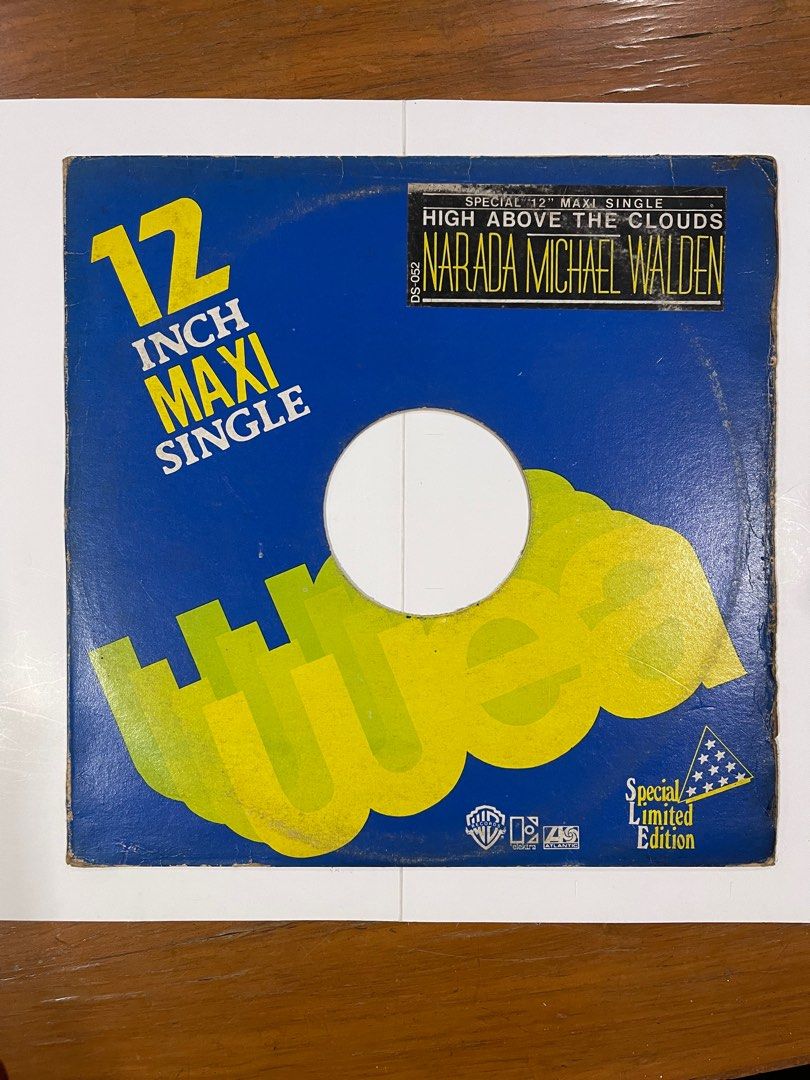 Narada Michael Walden - High Above The Clouds 12" Maxi Single (Category: Vinyls) located in Manila. Submitted by rtvarietystore (Listing ID 1414774809, Image 1). Description: Special edition 12-inch maxi single of Narada Michael Walden's "High Above The Clouds." The record features the song on one side. The cover has a blue background with yellow text and graphics. It includes the Warner Bros. Records and Atlantic Records logos. The record is in 