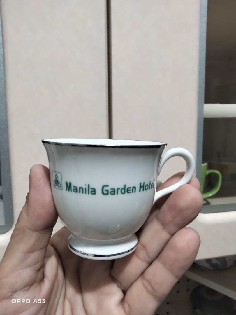 Noritake Manila Garden Hotel Cup (Category: Coffee & Tea Tableware) located in Carmona. Submitted by rpute (Listing ID 1414717749, Image 2). Description: - Vintage cup from the Manila Garden Hotel - Features the hotel's green logo and name - White cup with silver trim - Marked "Contemporary Fine China by Noritake Philippines" - Perfect for collectors of vintage hotel memorabilia.