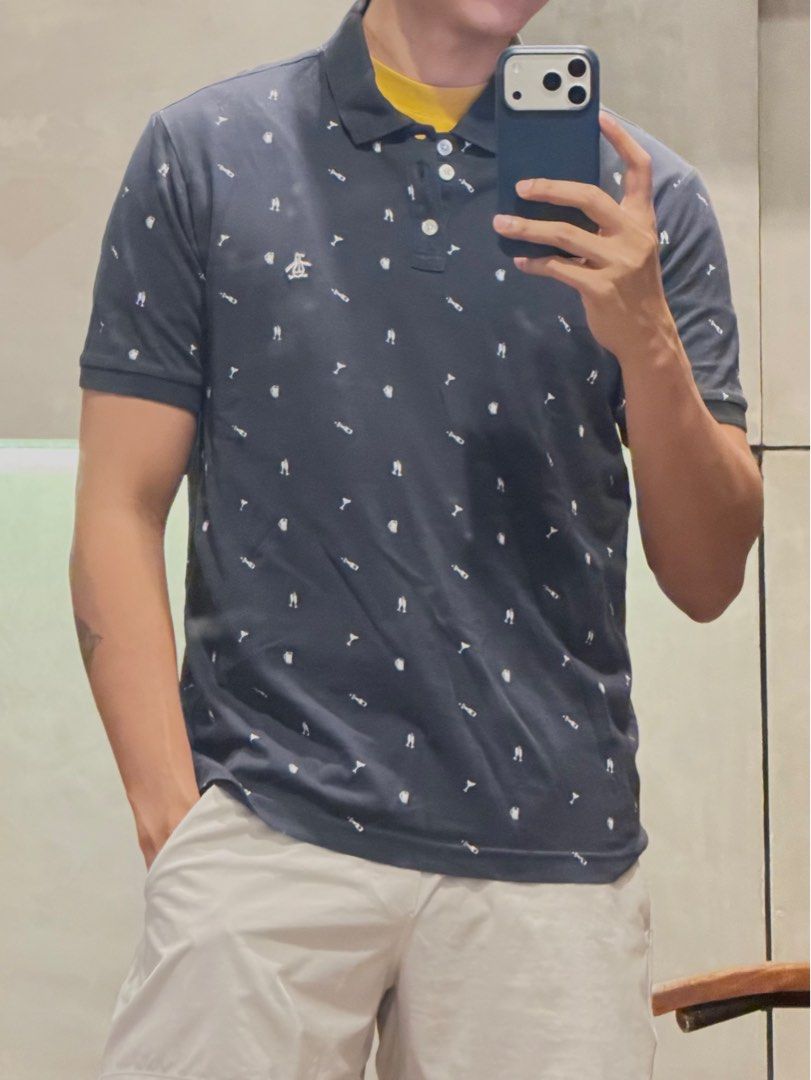 Original Penguin Polo Shirt - Medium (Category: Tshirts & Polo Shirts ) located in Taguig. Submitted by e_prc (Listing ID 1414745289, Image 2). Description: - Original Penguin polo shirt - Navy blue with white trim - Features small white icon pattern - Classic polo collar and short sleeves - Size: Medium - Made in Bangladesh - Issue: Fading from iron.