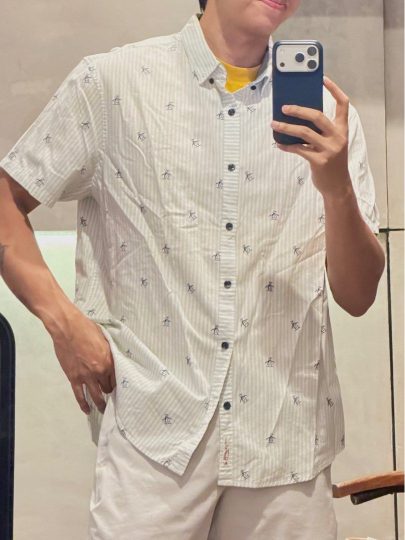 Original Penguin Striped Shirt (Category: Tshirts & Polo Shirts ) located in Taguig. Submitted by e_prc (Listing ID 1414746232, Image 1). Description: - Original Penguin short-sleeved shirt - Size: XL - Color: White with black stripes and penguin print - Features: Button-down, collar, chest pocket - Fit: Relaxed.