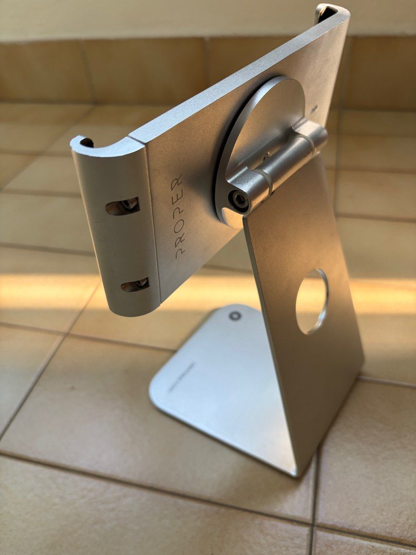 Proper Tablet Stand - Silver (Category: Mounts & Holders) located in Singapore. Submitted by bestpricelisted (Listing ID 1414726421, Image 2). Description: - Studio Studio Proper tablet stand - Made of aluminum - Sleek silver finish - Adjustable viewing angles (almost 360 swivel with portrait/ landscape options) - Securely holds tablet via screws - very stable compared to plastic stands - Minor dust/ residue - could be cleaned off - Ideal for des