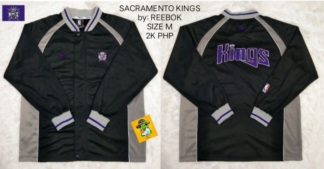 Reebok Sacramento Kings Jacket - Size M (Category: Coats, Jackets and Outerwear) located in Manila. Submitted by nxone (Listing ID 1414758355, Image 1). Description: Sacramento Kings jacket by Reebok. Features a black and grey color scheme with the Kings logo on the front and back. Includes a button-up front and ribbed cuffs. Size M. The jacket has a purple Kings logo on the front and back. The jacket has a grey and purple trim..