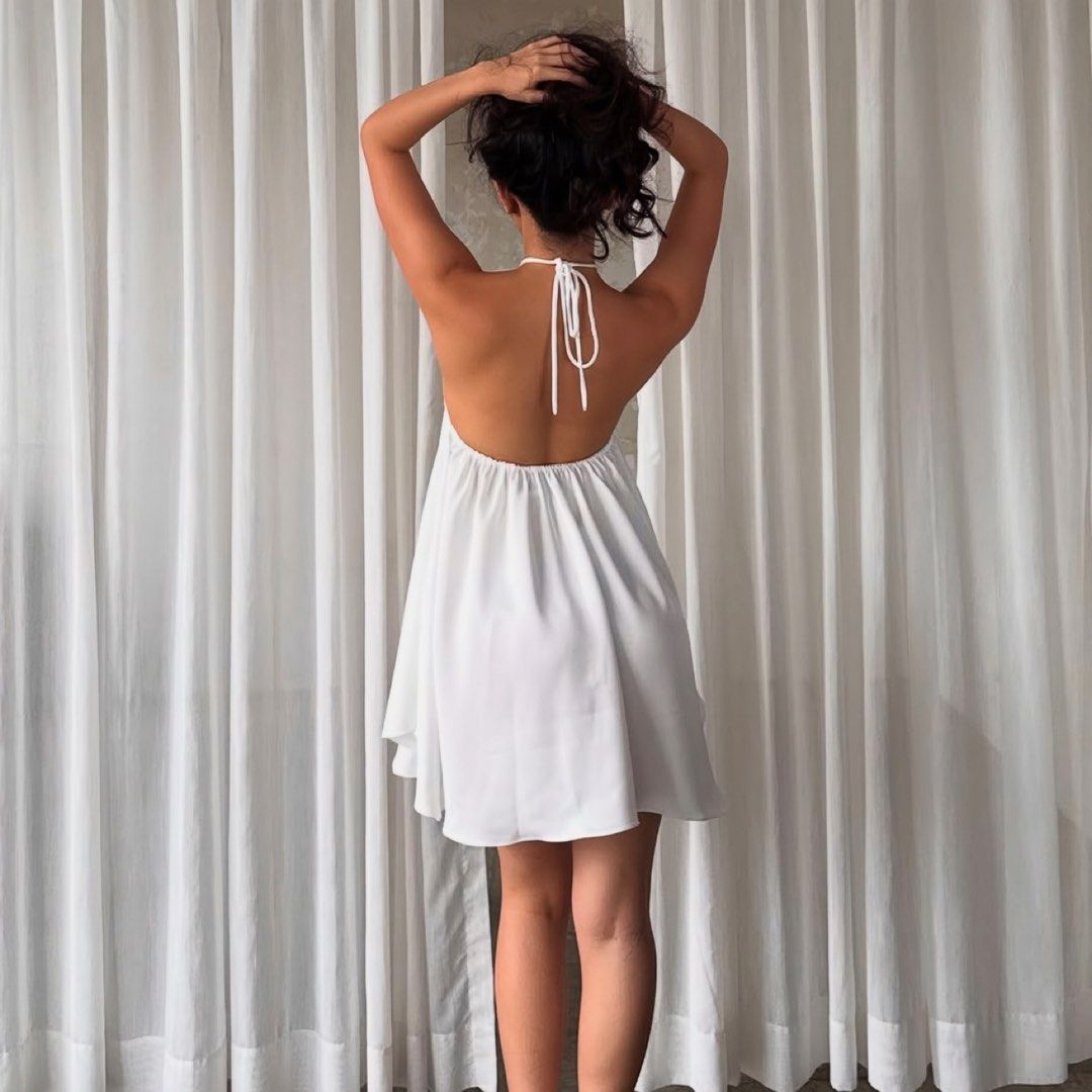 RENT: White Halter Silk Flowy Dress (Category: Dresses) located in Dasmarinas. Submitted by luvhrt (Listing ID 1414695537, Image 3). Description: 💌 Terms and Conditions: • Rental period is 3 days only (1. Pick-up, 2. Day of Use, 3. Return). • A deposit of ₱500 is required upon receiving the dress. This covers minor stains or small damages. • For major damage (tears, burns, irreversible stains), the renter will need to cover the full replacement 