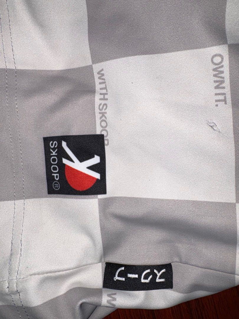 Skoop Checkered T-shirt XS (Category: Tshirts & Polo Shirts ) located in Quezon City. Submitted by batch. (Listing ID 1414813135, Image 3). Description: - Skoop checkered t-shirt (XS size) - Unique design with Japanese characters and "own it" phrase - Material: 88% polyester, 12% spandex - Care Instructions: - Warm/cold wash cycle - 40°C max - Use only neutral detergent - Line dry - Do not iron or bleach - Distributed by Feel Good Pep & Company I