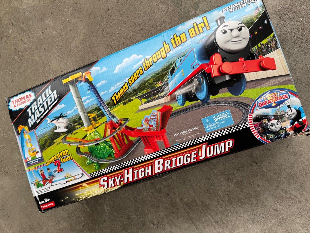Thomas & Friends TrackMaster Sky-High Bridge Jump (Category: Action & Battle Toys) located in Taguig. Submitted by kia______ (Listing ID 1414733136, Image 1). Description: Incomplete! No blue barrel Thomas & Friends TrackMaster Sky-High Bridge Jump motorized railway set. Features a track layout with a bridge jump, and includes various track pieces and accessories. The set is designed for children aged 3 and up. The box shows the set's features, i