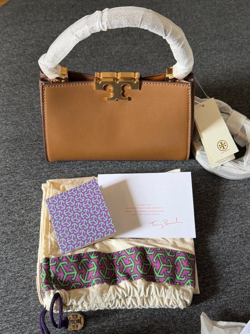 Tory Burch Eleanor Mini Satchel (Category: Luxury Bags & Wallets) located in Quezon City. Submitted by ayasofetch25 (Listing ID 1414654543, Image 1). Description: - Authentic Tory Burch Eleanor Mini Satchel bag - Color: Tan - Features: - Top handle - Gold-tone logo - Detachable strap - Multiple interior compartments - Protective wrapping on handle - Includes: Dust bag, tags, and cards.