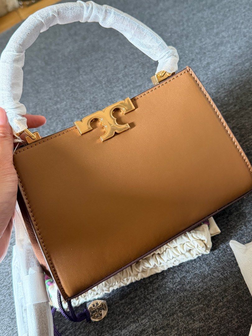 Tory Burch Eleanor Mini Satchel (Category: Luxury Bags & Wallets) located in Quezon City. Submitted by ayasofetch25 (Listing ID 1414654543, Image 2). Description: - Authentic Tory Burch Eleanor Mini Satchel bag - Color: Tan - Features: - Top handle - Gold-tone logo - Detachable strap - Multiple interior compartments - Protective wrapping on handle - Includes: Dust bag, tags, and cards.