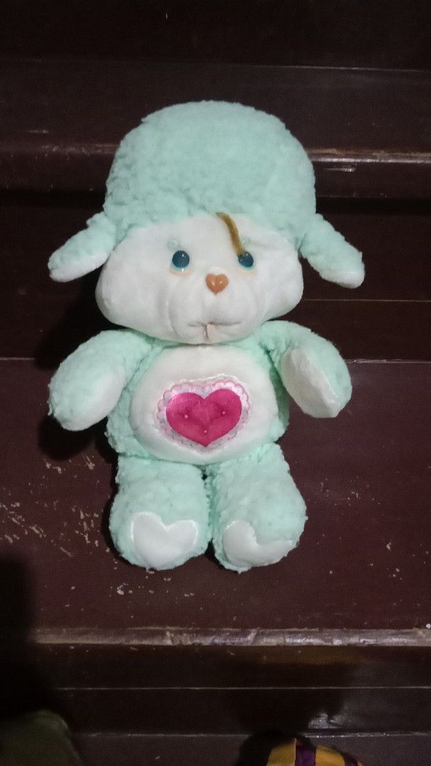 Vintage Care Bear Cousin Sheep Plush (Category: Plushies & Soft Toys) located in Cebu City. Submitted by monsterheart (Listing ID 1414650948, Image 1). Description: - Vintage Care Bear Cousin plush toy - Light green color - Sheep-like appearance - Features a heart on the chest and rear - negotiable - Blue eyes and brown nose.