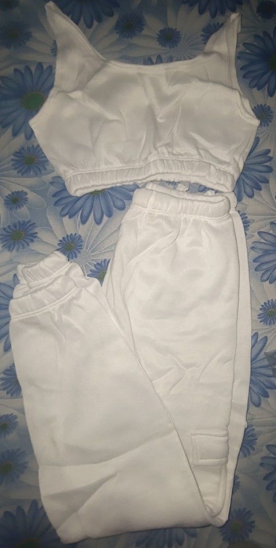 White Track Pants Set (Category: Sets or Coordinates) located in Manila. Submitted by declutterwithpassion (Listing ID 1414714839, Image 1). Description: - White tracksuit set - Includes a crop top and matching pants - Pants feature a cuffed ankle design - Made of soft material - Ideal for casual wear and lounging RFS: decluttering issue: need wash #declutter2026.