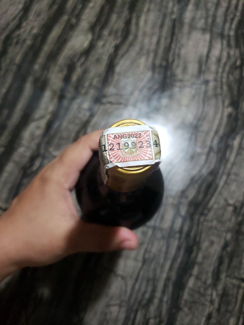 Wine Bottle (Category: Water Bottles & Tumblers) located in San Jose del Monte. Submitted by shegotit (Listing ID 1414738322, Image 2). Description: - Sealed wine bottle - Gold and white foil top - Dark bottle color - Partially visible label - Serial number: 1219923.