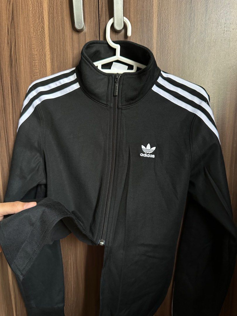 Adidas Track Jacket with 3 Stripes (Category: Coats, Jackets and Outerwear) located in Tagbilaran City. Submitted by icedcoconutlatte (Listing ID 1414897469, Image 2). Description: - Used once only - No flaws - Adidas black track jacket - White stripes on sleeves - Cropped style - Size: XS/TP - Full zip closure - Adidas logo on chest and zipper - Made in China.