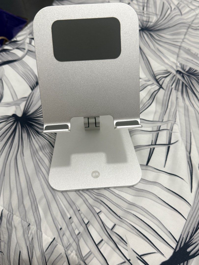 Adjustable Aluminum Tablet Stand (Category: Mounts & Holders) located in Cainta. Submitted by zairaelli (Listing ID 1415011006, Image 2). Description: - Silver aluminum phone stand - Foldable design - Adjustable viewing angles - Rectangular base - Compatible with various phone/ tablet sizes - Easy to store.