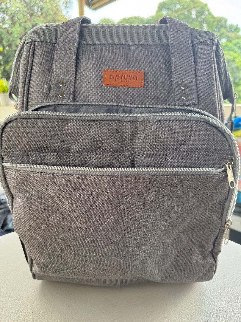 Apruva Mommy Bag - Grey (Category: Diaper Bags & Wetbags) located in Rizal. Submitted by tindahannialingpatring (Listing ID 1414873235, Image 1). Description: - Grey Apruva mommy bag - Multiple compartments and pockets for organization - Front zippered pocket - Two top handles - Adjustable shoulder straps - Insulated bottle pockets - Various interior storage compartments - Washable stain RFS: Decluttering, extra bag.