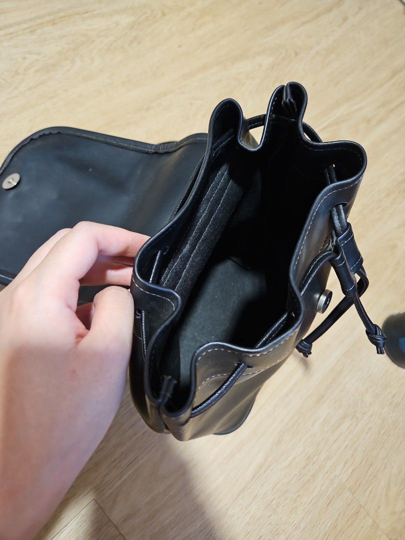 Black Drawstring Backpack (Category: Backpacks) located in Singapore. Submitted by chantelle03 (Listing ID 1414950735, Image 4). Description: - Stylish black backpack - Magnetic closure with drawstring details - Adjustable straps - Smooth, leather-like material - Big interior space, see water bottle and sunglasses for reference, can fit 1L bottle Minor imperfections, hardware has slight tarnishing /rust. not for fussy buyers, selling as is! Self 