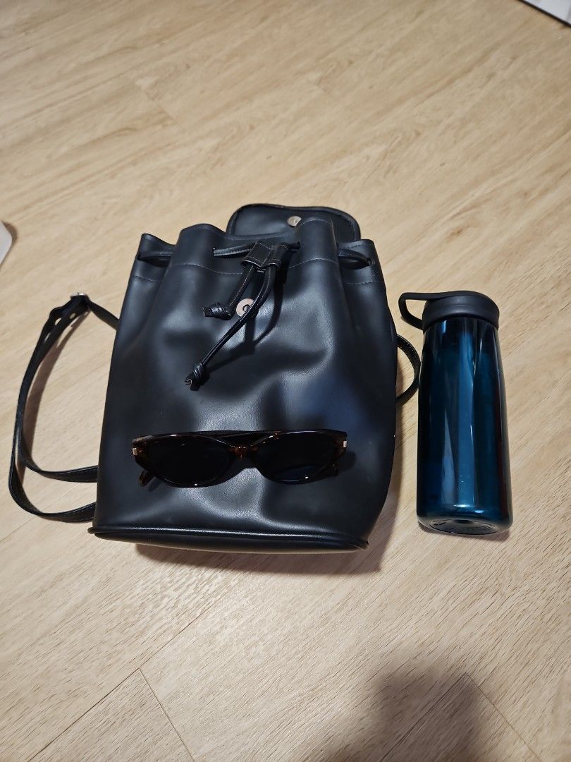 Black Drawstring Backpack (Category: Backpacks) located in Singapore. Submitted by chantelle03 (Listing ID 1414950735, Image 3). Description: - Stylish black backpack - Magnetic closure with drawstring details - Adjustable straps - Smooth, leather-like material - Big interior space, see water bottle and sunglasses for reference, can fit 1L bottle Minor imperfections, hardware has slight tarnishing /rust. not for fussy buyers, selling as is! Self 