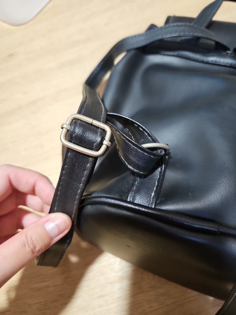 Black Drawstring Backpack (Category: Backpacks) located in Singapore. Submitted by chantelle03 (Listing ID 1414950735, Image 6). Description: - Stylish black backpack - Magnetic closure with drawstring details - Adjustable straps - Smooth, leather-like material - Big interior space, see water bottle and sunglasses for reference, can fit 1L bottle Minor imperfections, hardware has slight tarnishing /rust. not for fussy buyers, selling as is! Self 