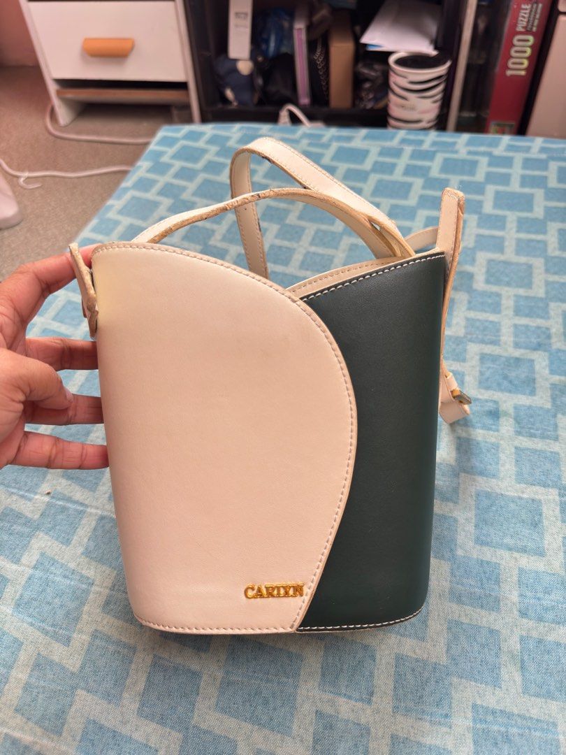 CARYN Bucket Bag (Category: Luxury Bags & Wallets) located in Cainta. Submitted by bellemoda.ph (Listing ID 1414869899, Image 1). Description: - CARYN bucket bag - Unique color block design (cream and dark green) - Top handle - Detachable shoulder strap - Drawstring closure - Interior pocket The only issue is ung rubber sticky kaya may mga dikit na something, but overall this is good pa pang ootd.