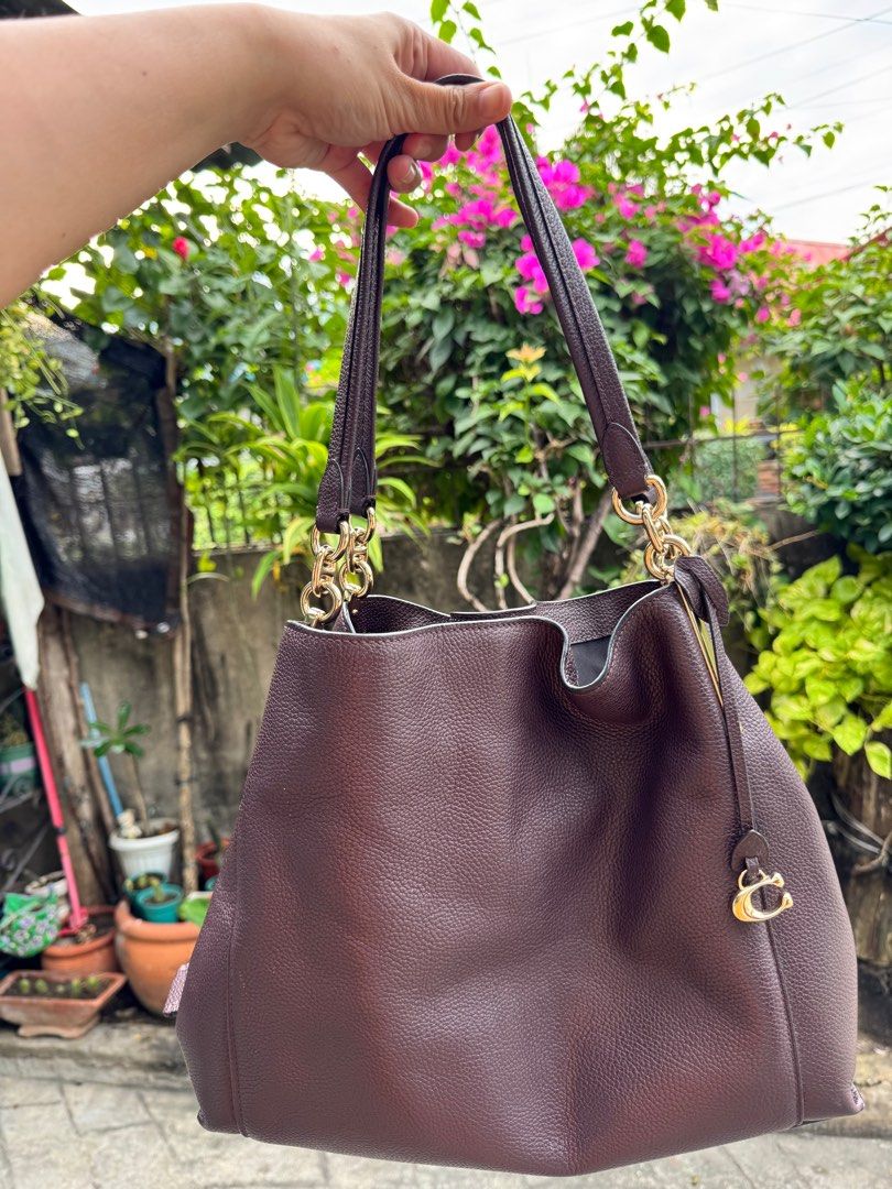Coach Dalton Hobo Bag (Category: Luxury Bags & Wallets) located in Palayan City. Submitted by decluttering_2018 (Listing ID 1414825479, Image 2). Description: Coach 73545 Coach Dalton 31 Metallic Coach Polished Pebble - Rich brown color - Gold-tone hardware - Spacious interior - Zippered pocket - Coach tag - Includes Coach logo charm - Structured shape - Comfortable shoulder strap - Protective feet at the bottom.