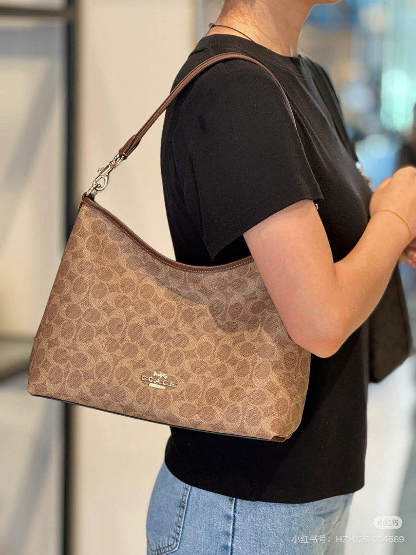 Coach Signature Shoulder Bag (Category: Luxury Bags & Wallets) located in Manila. Submitted by jay_cee241623 (Listing ID 1414882919, Image 2). Description: SUPERSALE COACH BAG 🤩 🖇 3,500+ SF 🖇 💯% Authentic & Brandnew 💯% Complete Inclusions - Coach shoulder bag - Signature Coach pattern - Neutral color - Brown leather strap - Gold-tone hardware - Curved shape - Coach logo on front - Suitable for everyday use.