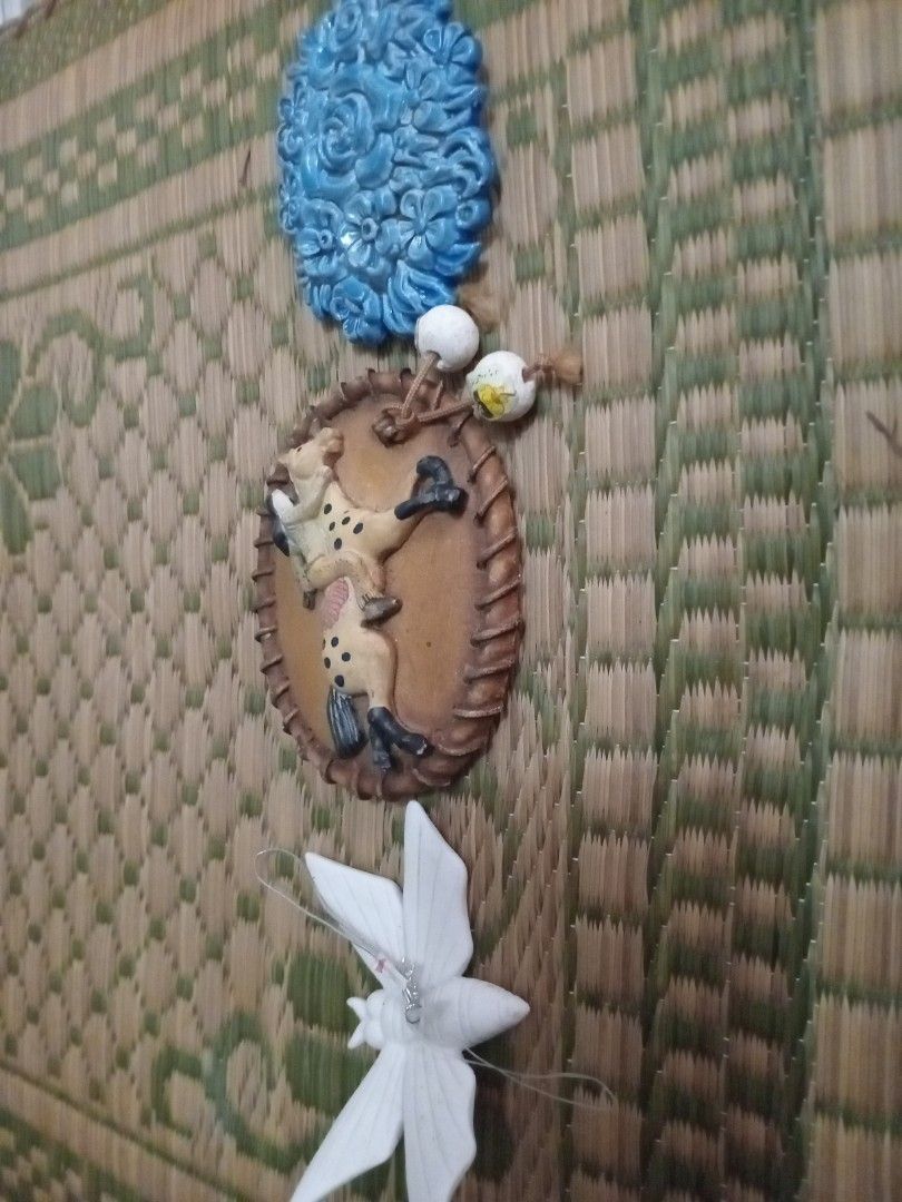 Decorative Wall Hangings display horse and accessories (Category: Wall Decor) located in Manila. Submitted by padillahe35291 (Listing ID 1414869730, Image 2). Description: Set of decorative wall hangings featuring a blue floral design, a clown figure, and a white flower. The clown figure is in an oval frame. The items are designed to be mounted on a wall..