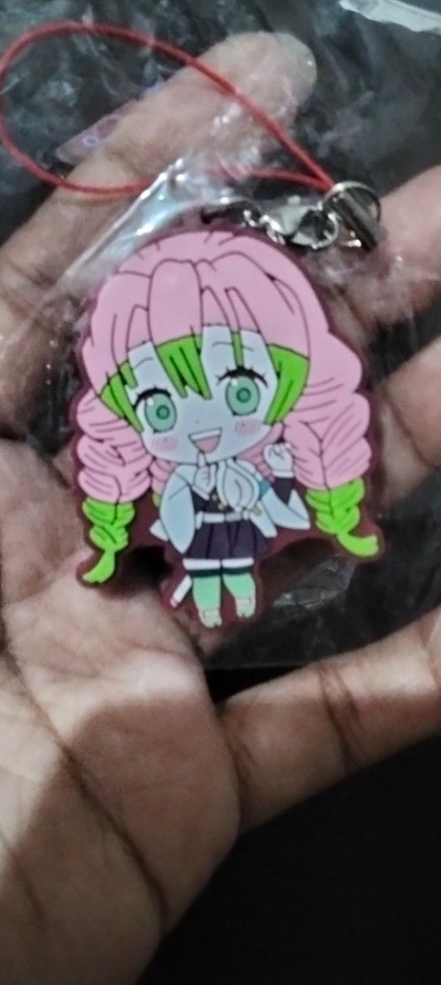 Demon Slayer Mitsuri Kanroji Keychain (Category: Character Goods) located in Santa Rosa. Submitted by animemerchcollection (Listing ID 1415016177, Image 1). Description: - Mitsuri Kanroji keychain - From Demon Slayer - Made of rubber - Includes red string and metal clasp - Brand new, in original packaging - Cute accessory for fans!.