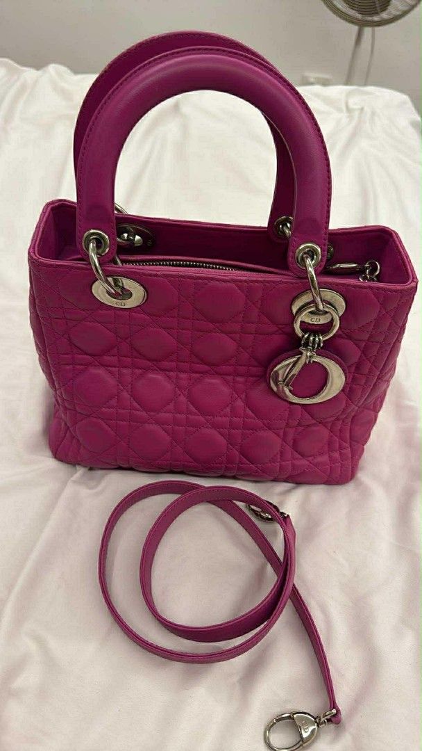 Dior Lady Dior Handbag (Category: Luxury Bags & Wallets) located in Caloocan City. Submitted by quinnnatha63205 (Listing ID 1415005095, Image 2). Description: - Authentic Lady Dior handbag - Stunning pink color - Classic quilted design - Dual top handles - Detachable shoulder strap - Secure zipper closure - Elegant silver-tone hardware - Interior lined with soft gray fabric - Protective metal feet at the base.