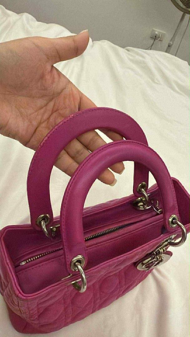 Dior Lady Dior Handbag (Category: Luxury Bags & Wallets) located in Caloocan City. Submitted by quinnnatha63205 (Listing ID 1415005095, Image 1). Description: - Authentic Lady Dior handbag - Stunning pink color - Classic quilted design - Dual top handles - Detachable shoulder strap - Secure zipper closure - Elegant silver-tone hardware - Interior lined with soft gray fabric - Protective metal feet at the base.