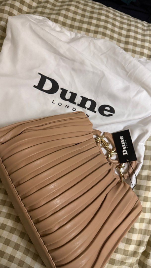 Dune London Pleated Handbag with Chain Strap (Category: Luxury Bags & Wallets) located in Makati City. Submitted by mrypauline (Listing ID 1414956383, Image 1). Description: - Dune London handbag - Pleated design - Light beige/nude color - Chain strap - Magnetic closure - Spacious interior - Unused condition - Includes dust bag and original tags - Adds sophistication to any outfit Rfs: ayaw nung reregaluhan :( .