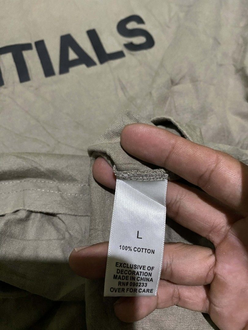 Essentials T-shirt - Olive Green - Size L (Category: Tshirts & Polo Shirts ) located in General Santos City (Dadiangas). Submitted by winter09503 (Listing ID 1415000174, Image 3). Description: Olive green Essentials T-shirt with the brand name printed on the front. Features a size L label. Made of 100% cotton. The shirt has a small Essentials label on the back. Made in China..