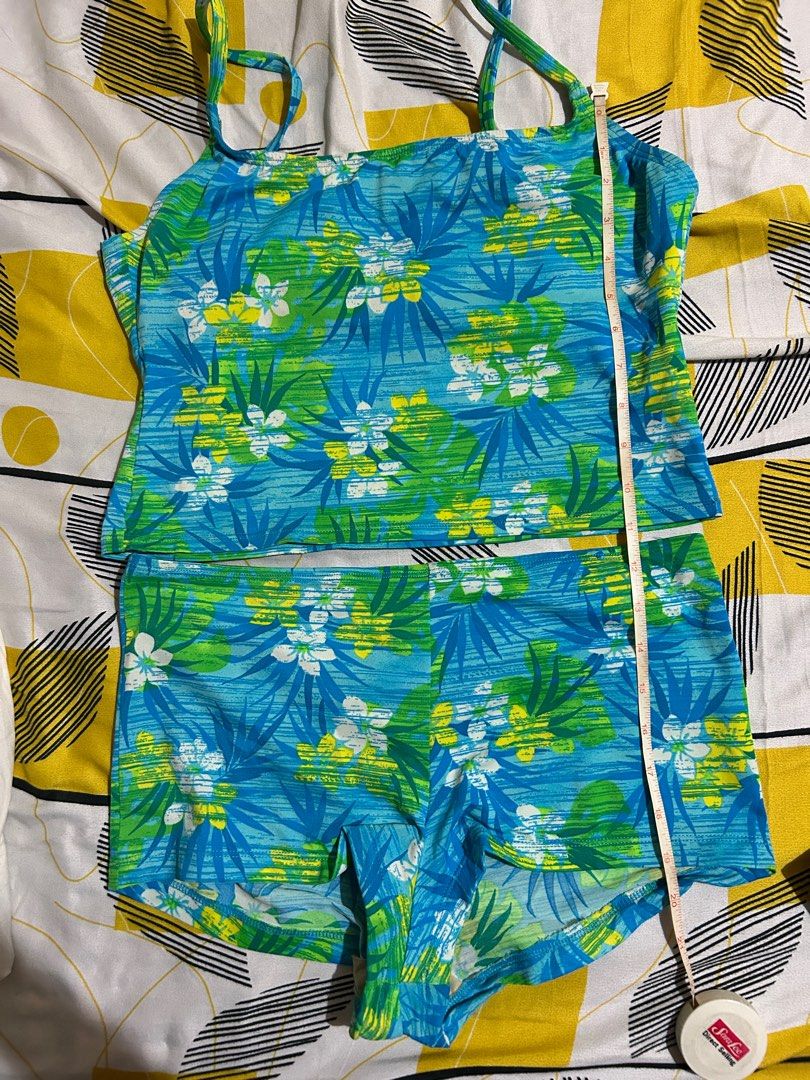 Floral Print Two-Piece Swimsuit (Category: Bikinis & Swimsuits) located in Pasay City. Submitted by volatile.waters (Listing ID 1414850828, Image 2). Description: - Two-piece swimsuit - Vibrant floral print (blue, green, yellow) - Tankini top with spaghetti straps - Comfortable shorts - Top length: 14 inches - Shorts length: 11 inches - Top width: 15 inches.