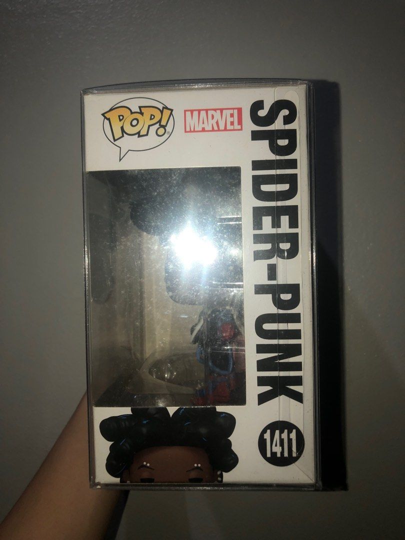 Funko Pop! #1411 Spider-Punk (Category: Designer & Blind Box Toys) located in Manila. Submitted by chlocharlm (Listing ID 1415023604, Image 2). Description: Bobblehead with stand. Never displayed out of box, opened once to check condition. Never displayed without BOSS protector. Comes with BOSS protector. .