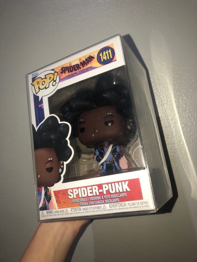 Funko Pop! #1411 Spider-Punk (Category: Designer & Blind Box Toys) located in Manila. Submitted by chlocharlm (Listing ID 1415023604, Image 1). Description: Bobblehead with stand. Never displayed out of box, opened once to check condition. Never displayed without BOSS protector. Comes with BOSS protector. .