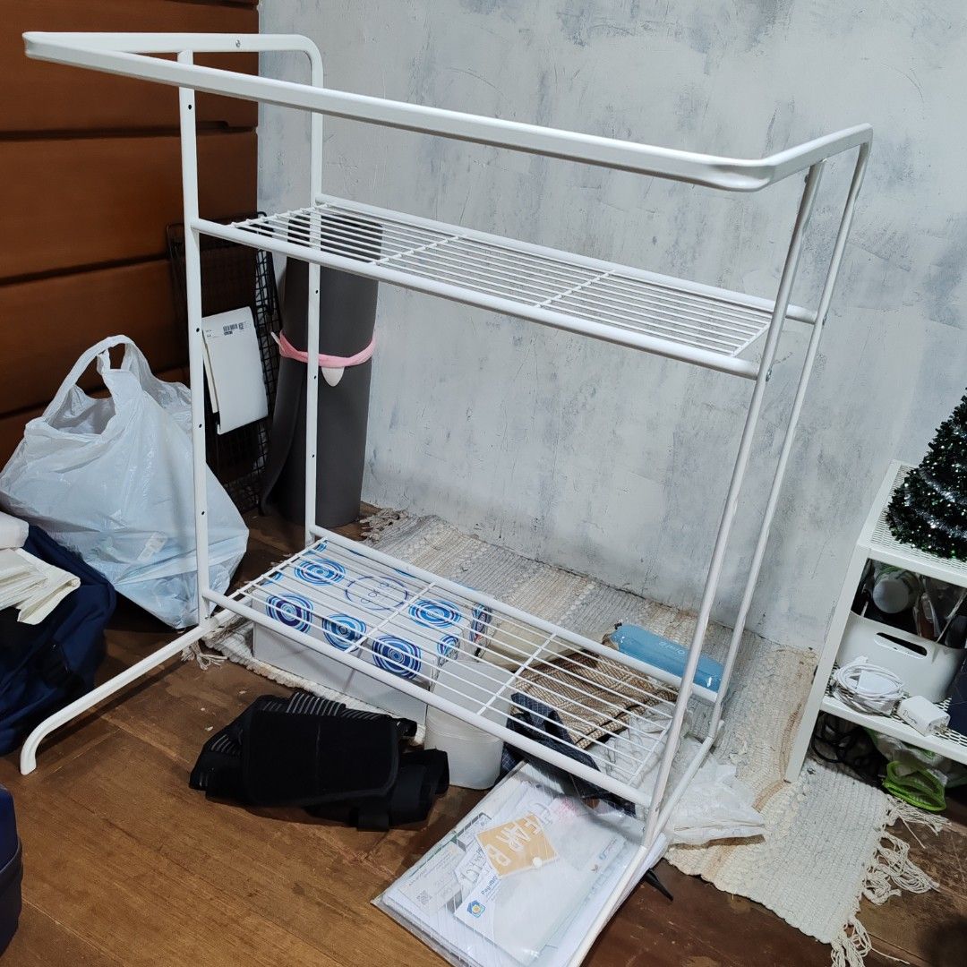 Ikea White Metal Clothes Rack with Shelves (Category: Shelves, Cabinets & Racks) located in Navotas City. Submitted by wild_bluebel (Listing ID 1414898683, Image 1). Description: - White metal clothes rack - Three wire mesh shelves - Top bar for hanging clothes - Sturdy frame - Simple design - Perfect for organizing clothes and other items - Ideal for bedrooms, laundry rooms, or any space needing extra storage.