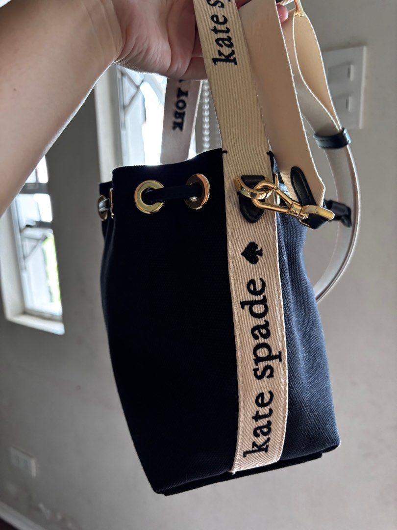 Kate Spade New York Bucket Bag (Category: Luxury Bags & Wallets) located in San Pablo. Submitted by aceastra (Listing ID 1414897403, Image 2). Description: - Kate Spade New York bucket bag - Black exterior - Beige detachable crossbody strap - Drawstring closure - Gold-tone hardware - Interior branded with Kate Spade New York label - Canvas.