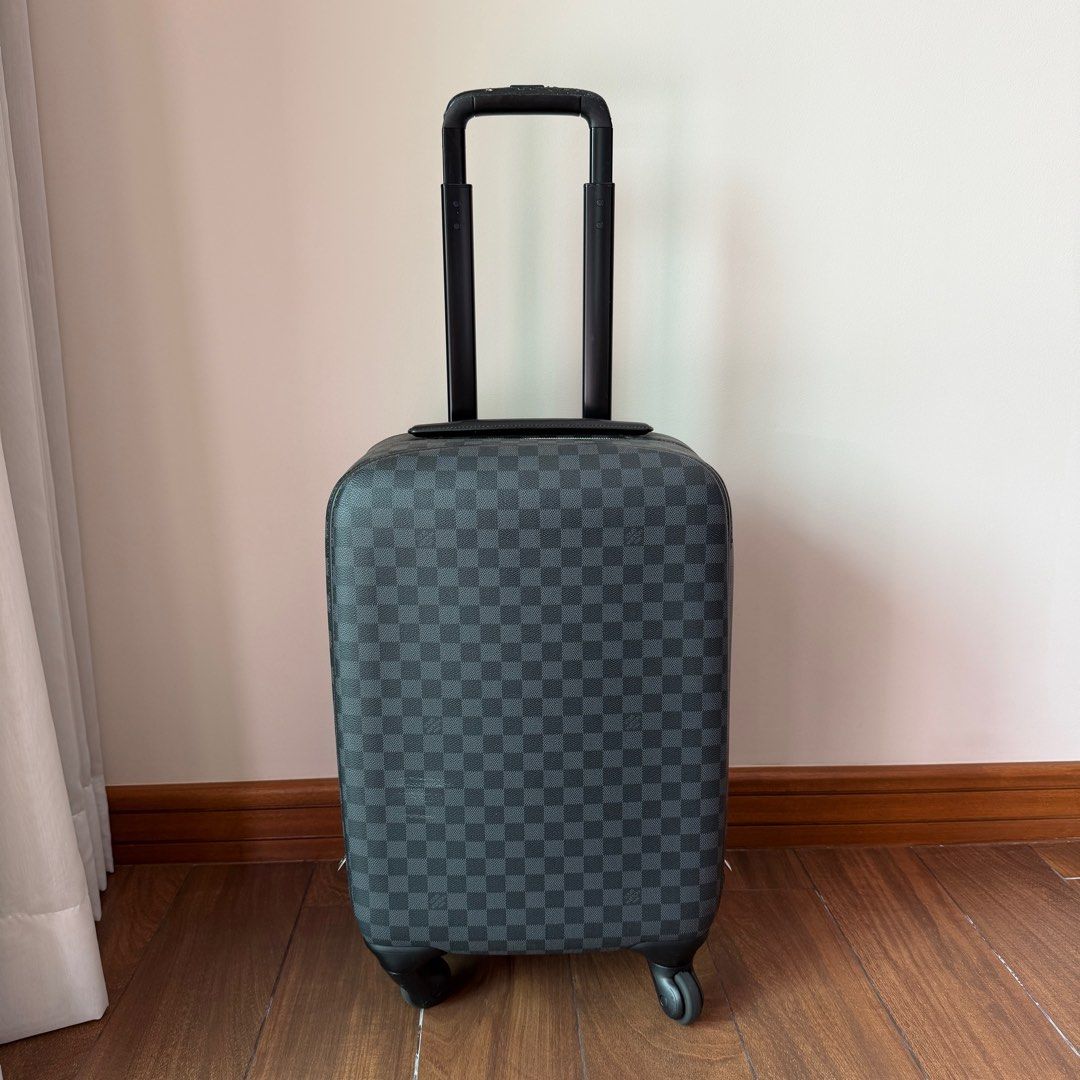 Louis Vuitton Damier Graphite Zephyr 55 Rolling Suitcase (Category: Luxury Bags & Wallets) located in Quezon City. Submitted by prelovedbygirliess (Listing ID 1414847625, Image 1). Description: SRP: PHP 225,000 Material: Damier Graphite coated canvas with leather trim Includes: LV dust bag, Production Year: 2013 Measurements: 14” L x 9” W x 21” H Interior Pockets: Three zip pockets Handles: Retractable handle with leather handle Handle Drop: 22” 