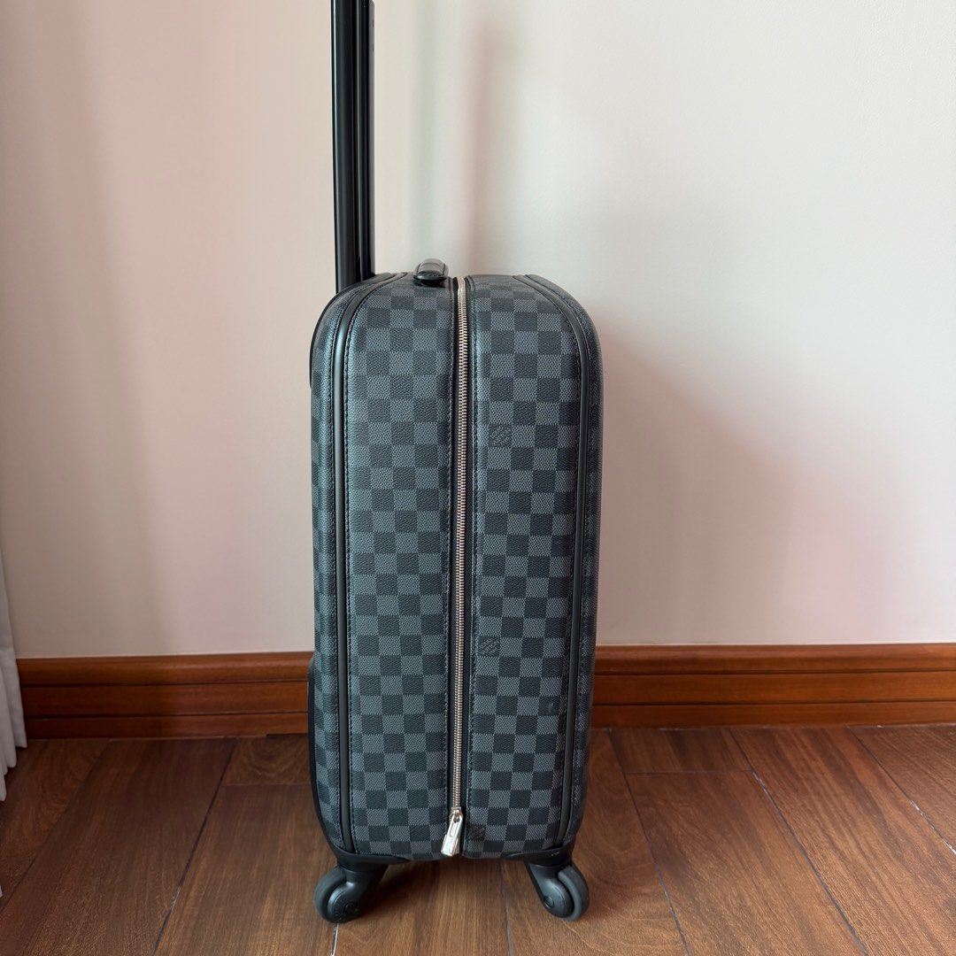 Louis Vuitton Damier Graphite Zephyr 55 Rolling Suitcase (Category: Luxury Bags & Wallets) located in Quezon City. Submitted by prelovedbygirliess (Listing ID 1414847625, Image 2). Description: SRP: PHP 225,000 Material: Damier Graphite coated canvas with leather trim Includes: LV dust bag, Production Year: 2013 Measurements: 14” L x 9” W x 21” H Interior Pockets: Three zip pockets Handles: Retractable handle with leather handle Handle Drop: 22” 