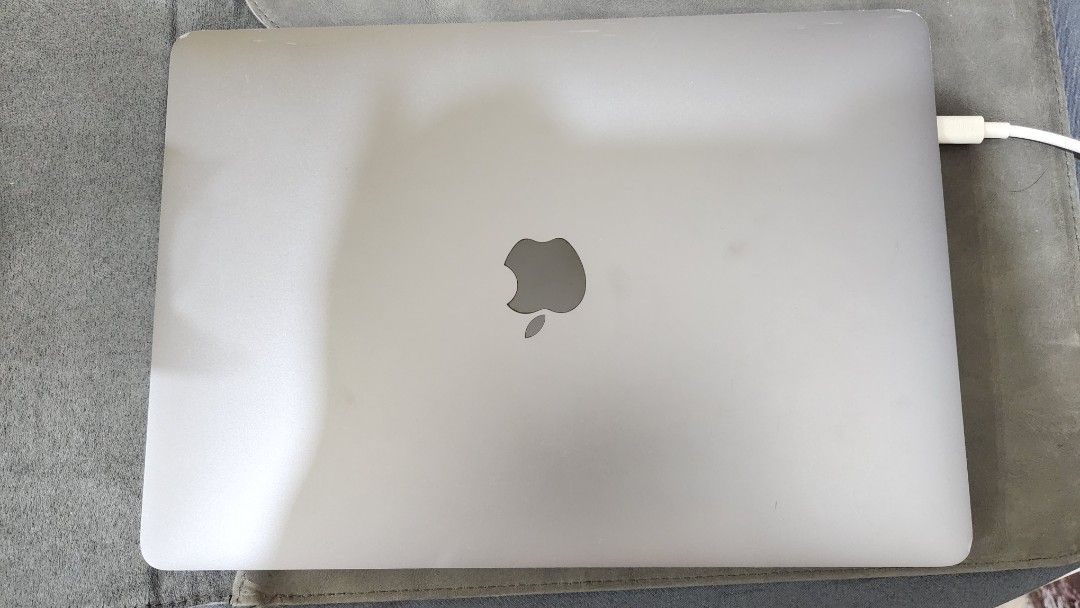 MacBook Pro 2017 Touchbar (Category: Laptops & Notebooks) located in Manila. Submitted by preloved_essentials (Listing ID 1415031744, Image 3). Description: - Silver MacBook Pro laptop - Black keyboard - Mint green keyboard cover - Includes charging adapter - See video for display details - Features four rubber feet on the bottom.