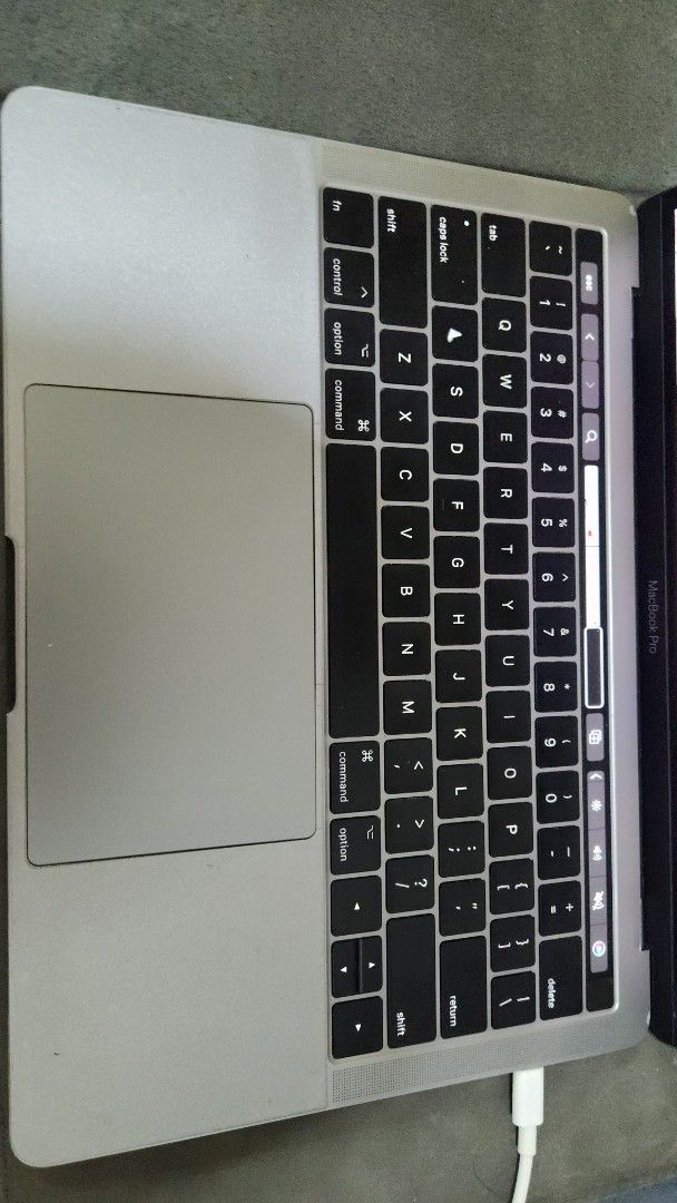 MacBook Pro 2017 Touchbar (Category: Laptops & Notebooks) located in Manila. Submitted by preloved_essentials (Listing ID 1415031744, Image 2). Description: - Silver MacBook Pro laptop - Black keyboard - Mint green keyboard cover - Includes charging adapter - See video for display details - Features four rubber feet on the bottom.