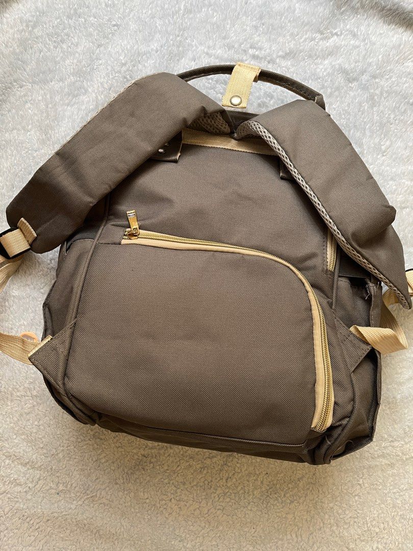 Mama's Choice Diaper Bag (Category: Diaper Bags & Wetbags) located in Malolos. Submitted by wabzky24 (Listing ID 1414830928, Image 3). Description: - Mama's Choice diaper bag - Neutral brown color with beige accents - Multiple compartments and pockets for organized storage - Front zippered pocket - Side pockets - Top handle - Adjustable shoulder straps - Top zipper closure - Minor tear on top seam - SF will be shouldered by the buyer.