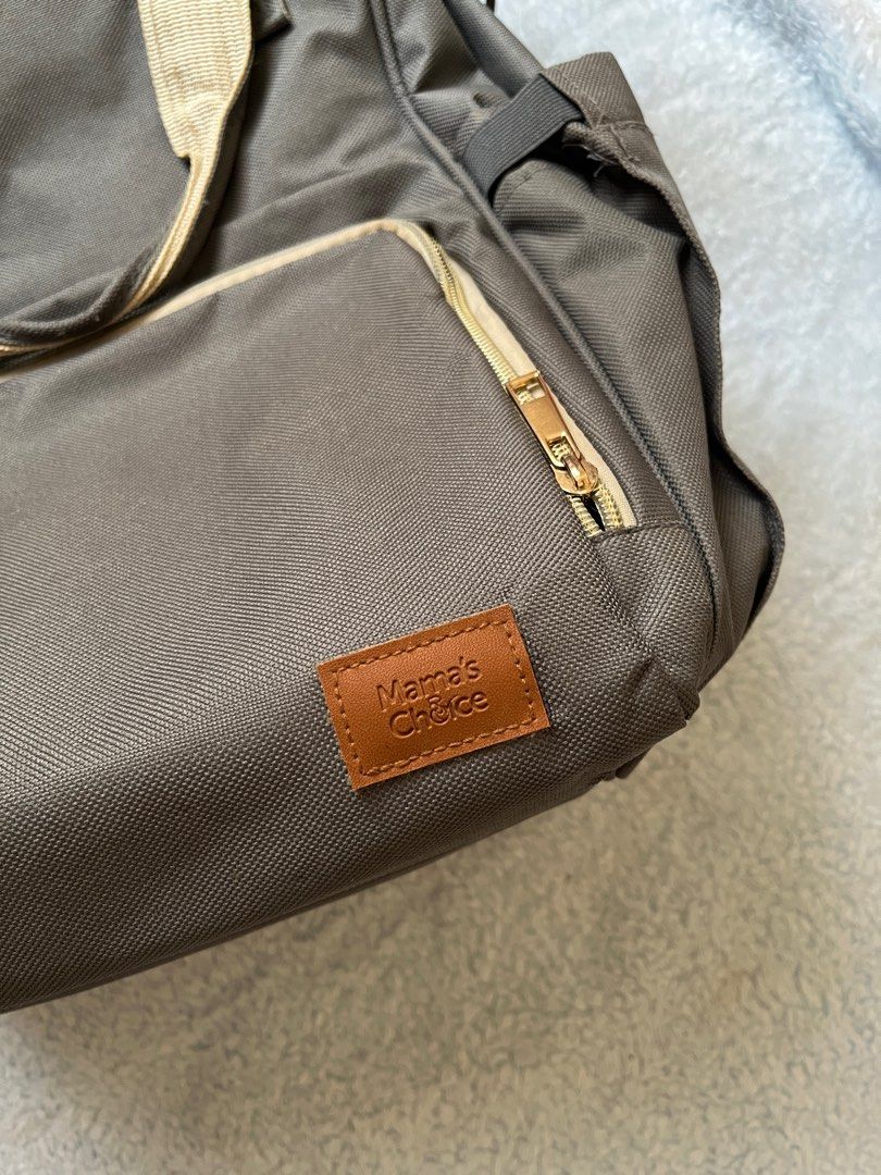 Mama's Choice Diaper Bag (Category: Diaper Bags & Wetbags) located in Malolos. Submitted by wabzky24 (Listing ID 1414830928, Image 2). Description: - Mama's Choice diaper bag - Neutral brown color with beige accents - Multiple compartments and pockets for organized storage - Front zippered pocket - Side pockets - Top handle - Adjustable shoulder straps - Top zipper closure - Minor tear on top seam - SF will be shouldered by the buyer.