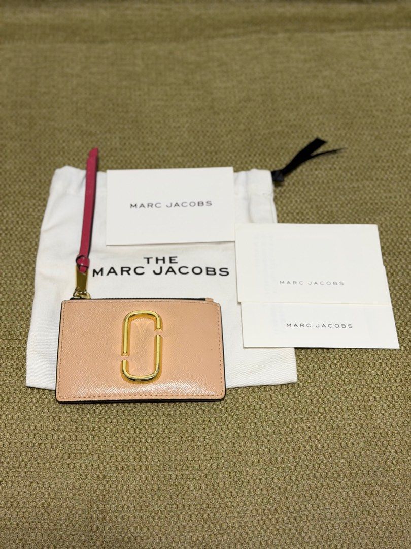 Marc Jacobs Snapshot Wallet (Category: Luxury Bags & Wallets) located in Marikina City. Submitted by yourfashionpill (Listing ID 1414980436, Image 2). Description: - Authentic and original. Bought in Japan (still comes with the receipt) - Blush pink color, gold hardware - Includes dust bag and cards - Shows signs of use (some tarnishing and scratches on hardware) - Leather is still intact - no scuffs or any peeling.