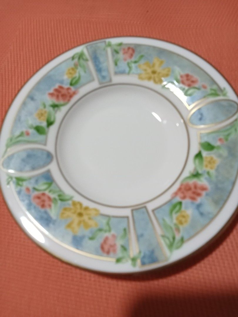 2 pcs Pierre Balmain Floral Design Saucers (Category: Dinnerware & Cutlery) located in Tagaytay City. Submitted by vianang (Listing ID 1414890670, Image 3). Description: - Set of ceramic plates - Features a beautiful floral design - Colors: Blue, yellow, and red accents - White center - Gold trim - Light blue background with floral patterns.