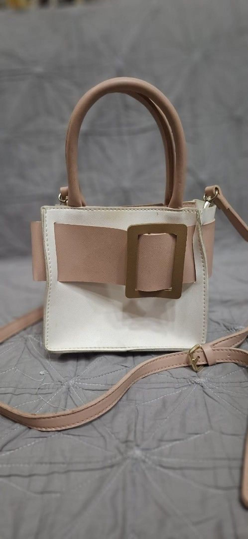 Pink and White Handbag with Buckle (Category: Shoulder Bags) located in Makati City. Submitted by icesena09 (Listing ID 1415023263, Image 1). Description: - Color block design in pink and white - Top handle - Detachable shoulder strap - Buckle closure - Interior pocket - Chic accessory for everyday use.